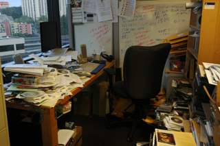Photograph of an extremely cluttered office.
